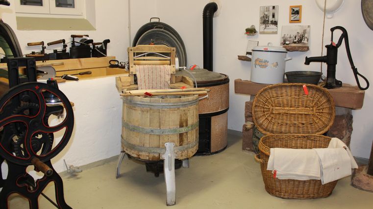 A room with vintage washing devices and baskets. Old household items showcase the tradition of laundry care.