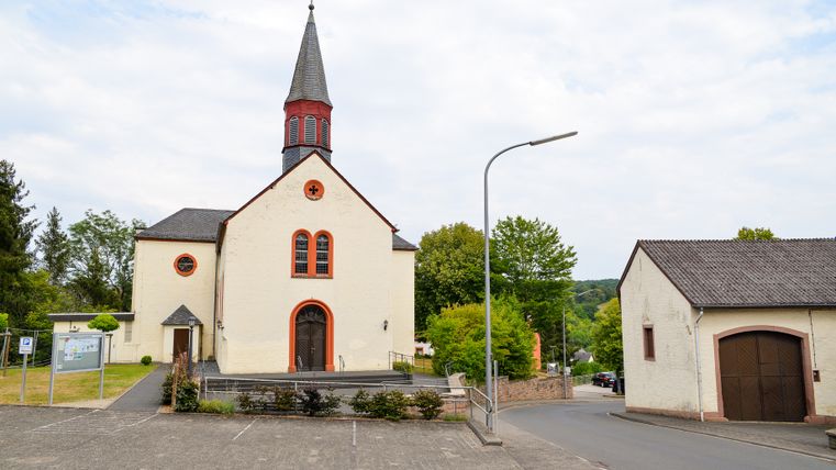 Church in Wißmannsdorf with parking lot and surrounding street.