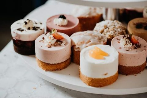 A lovingly arranged selection of jars filled with various jams and cookies. Each jar is equipped with a handwritten label.