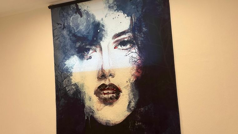 Une œuvre d'art moderne avec le visage d'une femme. Les couleurs sont sombres et intenses, ce qui donne à l'image une atmosphère dramatique.