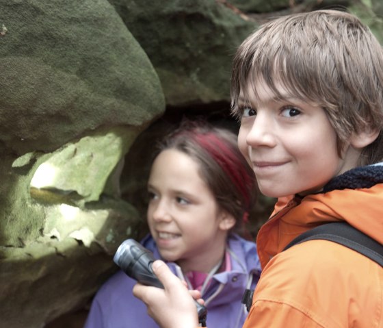 Kinder erforschen die Verwitterung im Sandstein, © Felsenland Südeifel Tourismus GmbH